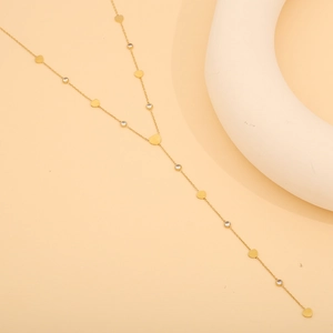 Detail of gold-plated Y-shaped necklace featuring heart sequins and zircon accents