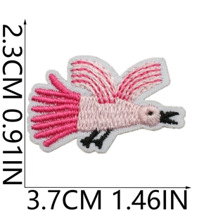 Macro detail of bird embroidery patch in pink with dimensions 2.3x3.7cm on white background