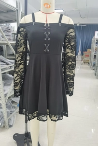 Close-up of the black gothic dress featuring lace sleeves and crisscross tie details
