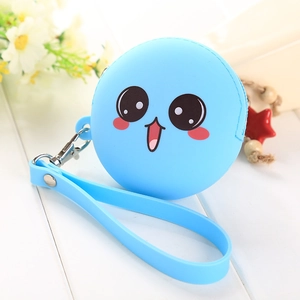 Blue silicone cookie coin purse with cartoon expression and wrist strap on white wood