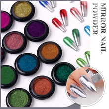 Close-up of mirror nail powder jars and gradient metallic nail art swatches