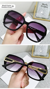 Detail of square black sunglasses with gradient lenses and gold hollow metal temples