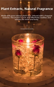 Macro shot of a lit glass jelly candle with dried rose buds and warm amber glow