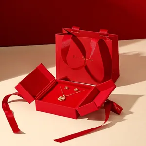 Golden clover necklace and rose earrings set in a red gift box with matching carry bag