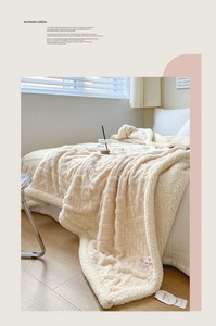 Detail of cream double-sided coral fleece blanket with geometric textured plush patterns