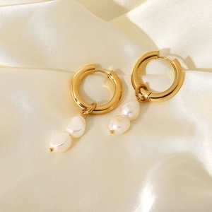 Detail of 18K gold plated hoop earrings with double freshwater pearls on silk background
