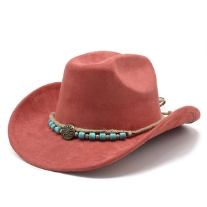 Macro shot of faux suede cowboy hat featuring turquoise beads and sun-patterned metal concho