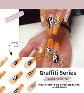 Faux ongles graffiti avec ombré orange, motifs marguerites et tai-chi yin yang