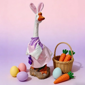 Detail view of 23-inch porch goose in Easter bunny outfit with pink ears and apron