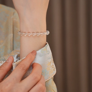 Close-up of clear white crystal beaded bracelet on wrist showing transparent luster