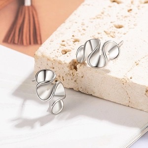 Irregular silver cream flower stud earrings with minimalist wavy abstract design