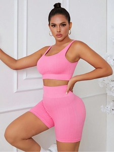 Close-up of pink ribbed yoga set featuring a seamless sports bra and high waist shorts
