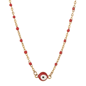 Detailed macro view of golden stainless steel necklace with red beads and evil eye pendant