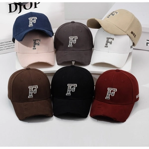 Detailed view of eight vintage distressed baseball caps with embroidered F letter patches