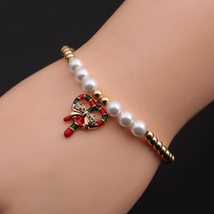 Detail of Christmas candy cane charm bracelet with colorful zircons and pearls