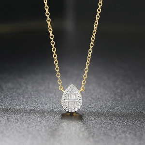 Macro shot of two-tone water drop pendant necklace with shimmering cubic zirconia stones