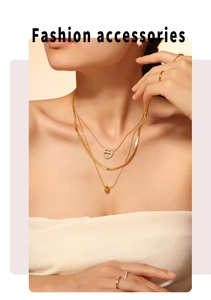 Close-up of a three-layer gold necklace featuring a heart-shaped pendant with MAMA engraving