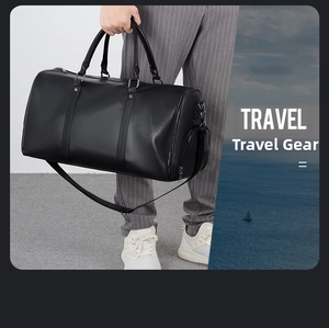 Detail of black faux leather travel bag with shoe compartment and adjustable strap