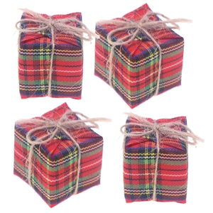 Close-up of Christmas Scottish plaid fabric gift box ornaments with natural twine bows