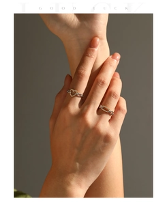 Close-up of S925 silver heart ring and diamond chain band worn in a stack