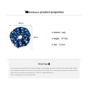 Detail view of large blue floral cloth scrunchie with 20cm diameter size specifications