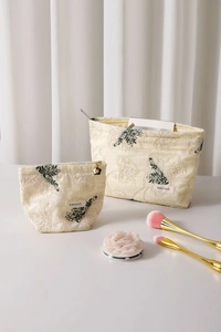 Detail of floral embroidered cotton linen makeup bags with H&R BAG woven label texture