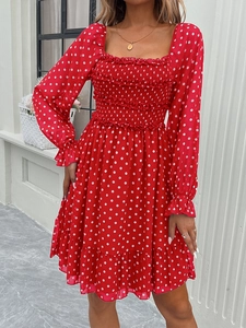 Detail of red polka dot dress featuring square neck, long sleeves and ruffled hem design