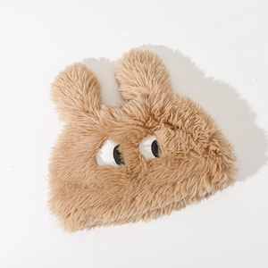 Detail of soft khaki faux fur texture and large cartoon eyes on the winter bucket hat