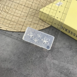 Detailed size measurement of a clear silicone rose flower nail art mold with ruler scale