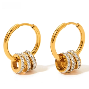 Detail view of gold hoop earrings with sparkling crystal pavé and polished charms