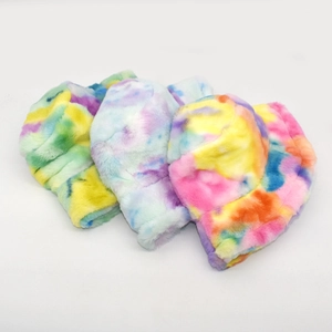 Detailed view of three colorful tie-dye faux fur bucket hats for winter warmth