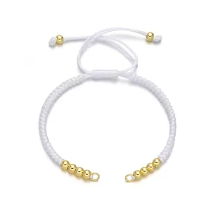 Handmade woven white cord bracelet with gold beads and adjustable metallic clasp closure