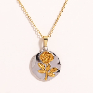 Detail of sunflower pendant on golden chain with vintage floral relief on silver medallion