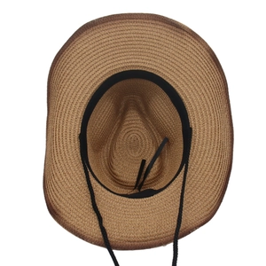 Detail of breathable straw hat interior featuring a black sweatband and adjustable chin strap