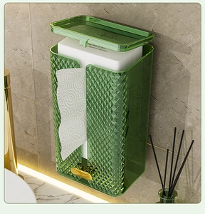 Detail of luxury green textured wall-mounted tissue box with gold handle in bathroom