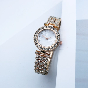 Elegant gold quartz watch for women featuring a full rhinestone bezel and pearl dial