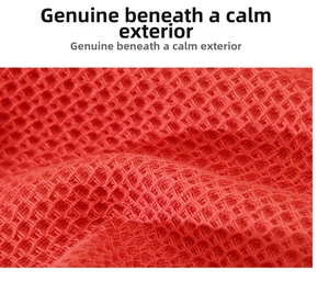 Macro detail of red cotton waffle texture fabric with deep honeycomb weave pattern