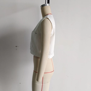Detail shot of white cargo vest side pocket and neat stitching on durable cotton canvas