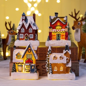 Lighted Christmas village houses set with snow details for festive tabletop decoration