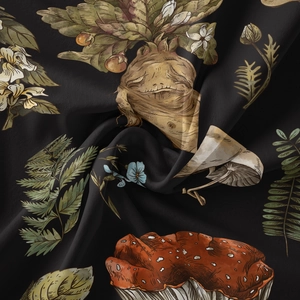 Macro shot of fabric texture featuring vintage red mushroom and botanical illustrations