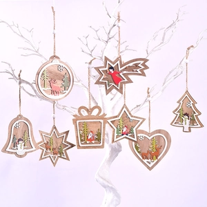 Various wooden Christmas ornaments with festive carvings hanging on a white branch