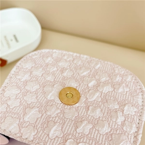 Pink floral texture mini handbag with a golden magnetic clasp and pearl handle accents