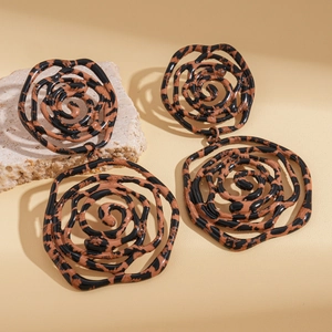 Detail of vintage leopard print flower earrings with glossy resin texture and 3D petals