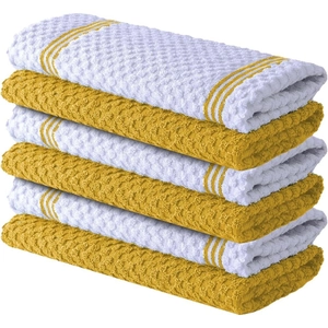 Close-up of stacked yellow and white waffle weave cotton dish towels with side stripes