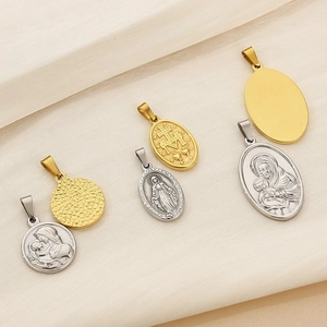 Detailed close-up of religious stainless steel pendants in gold and silver finishes