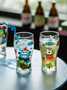 Close-up of glass tumblers with cute cartoon panda prints and fresh lime slices