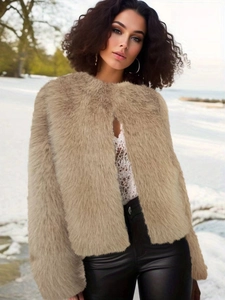 Short faux fur jacket in khaki color with round neck, shown against a snowy landscape