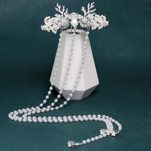 Macro shot of silver deer antler hairpin with white pearls and long hanging tassels