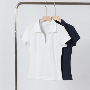 Detail of white and navy blue short-sleeved retro polo shirts with V-neck collar design