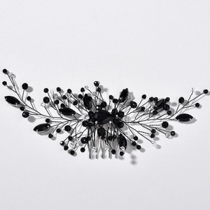 Detail of silver bridal hair comb with emerald green crystals and handcrafted wire work